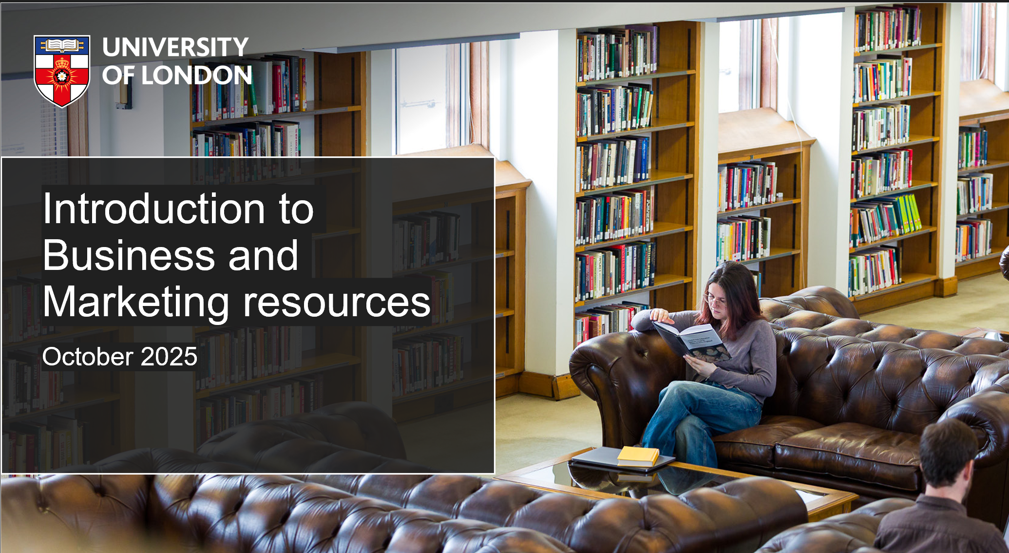 Image of student reading study guide in library