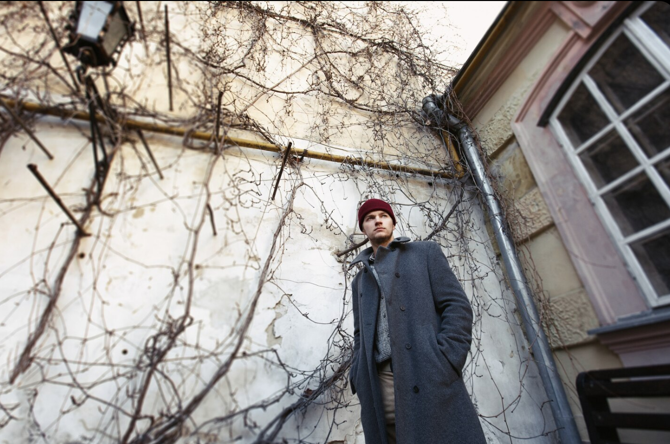 man in grey coat in east berlin 