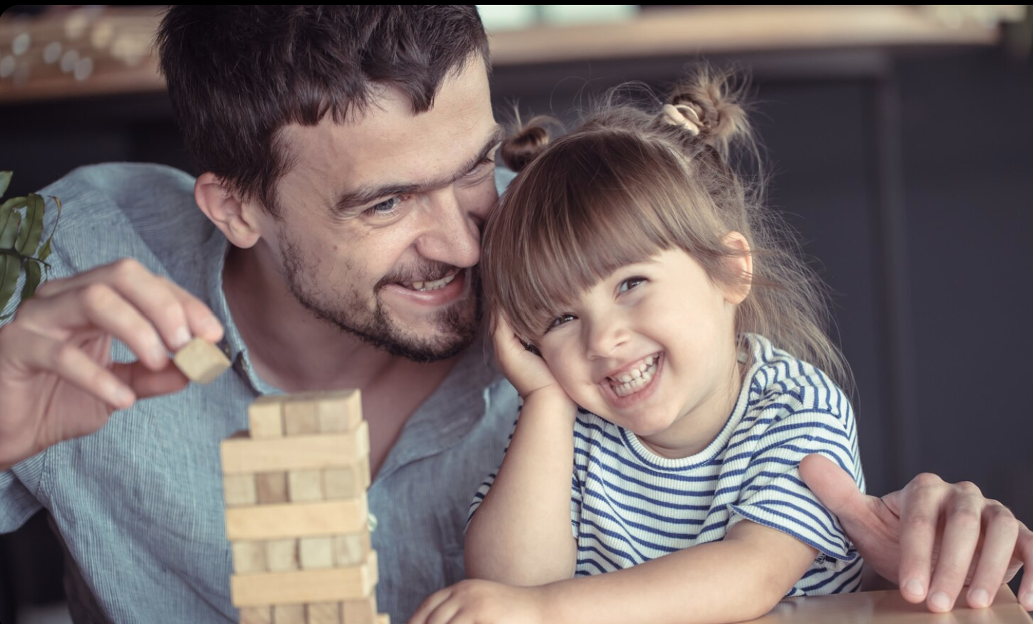 daddy and toddler girl playing jenga