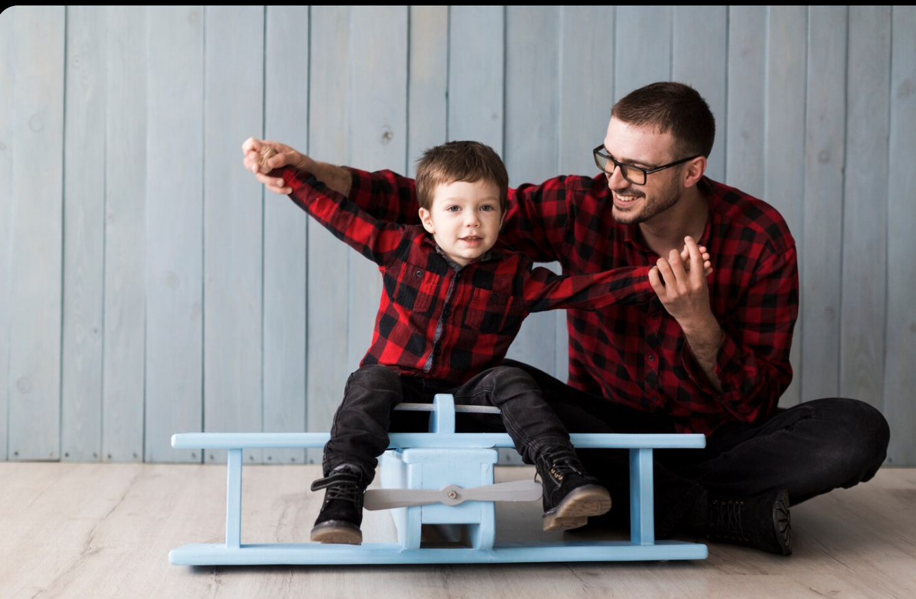 dad holds son in matching outfit on airplane