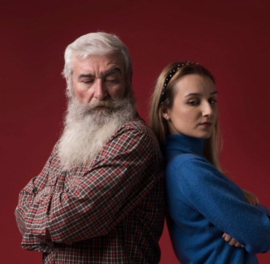 father and daughter standing back toback