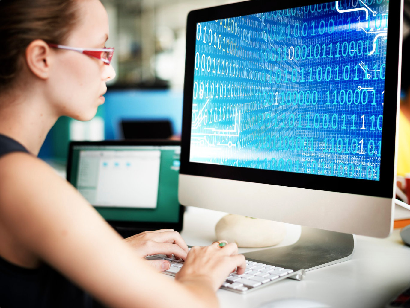 female student coding on computer