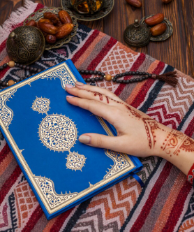 women's hand with bindi print holds quran