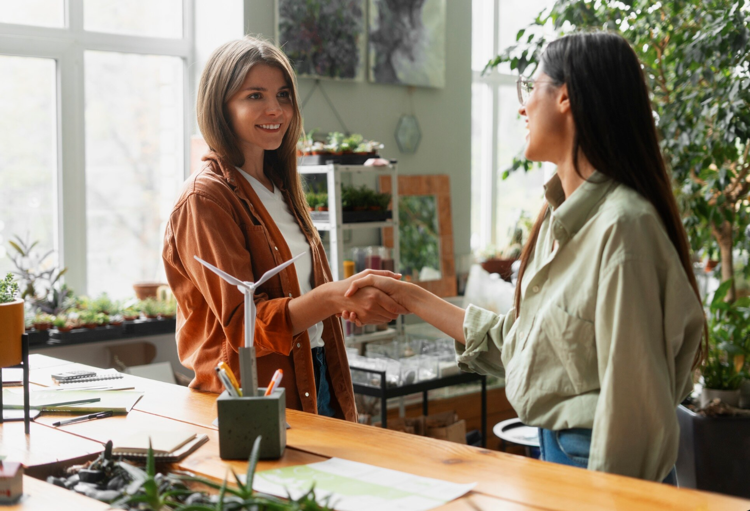 women shaking hands in eco friendly laboratory