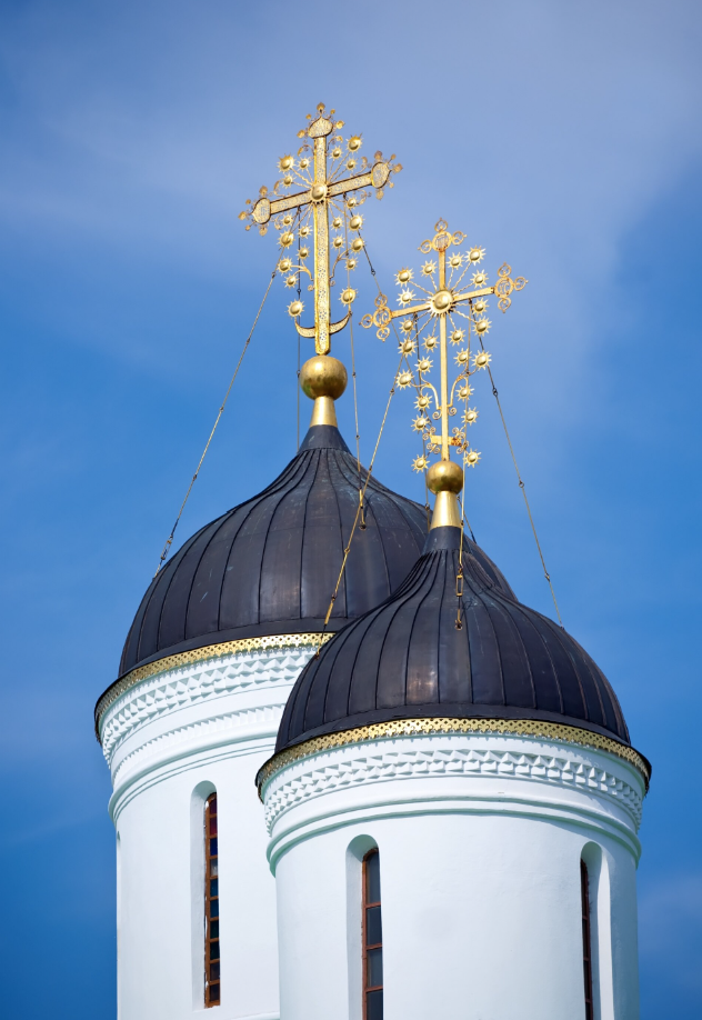two orthodox gold crosses above a church