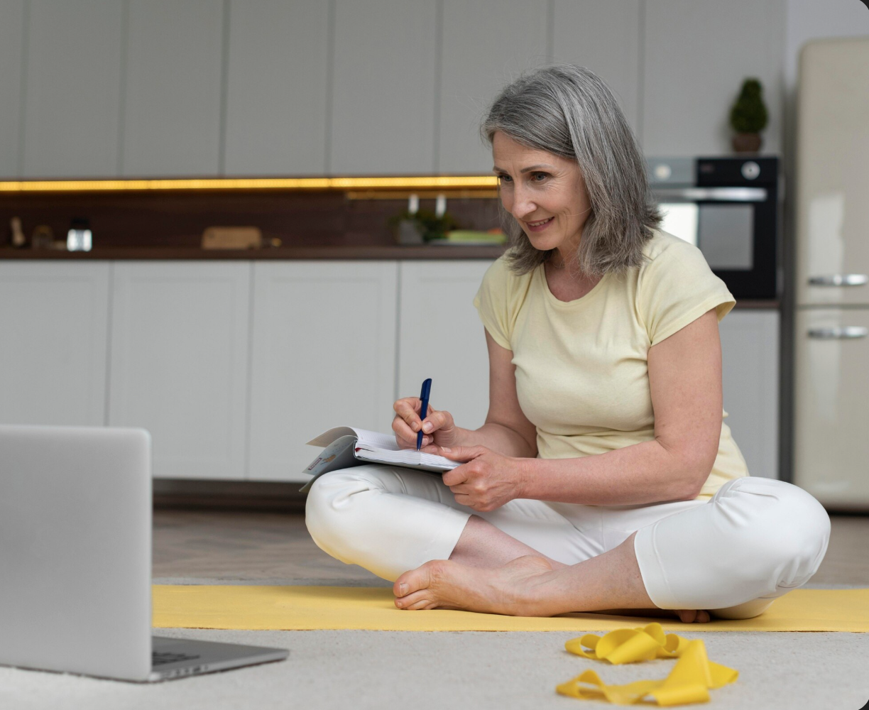 woman cross legged studies at computer