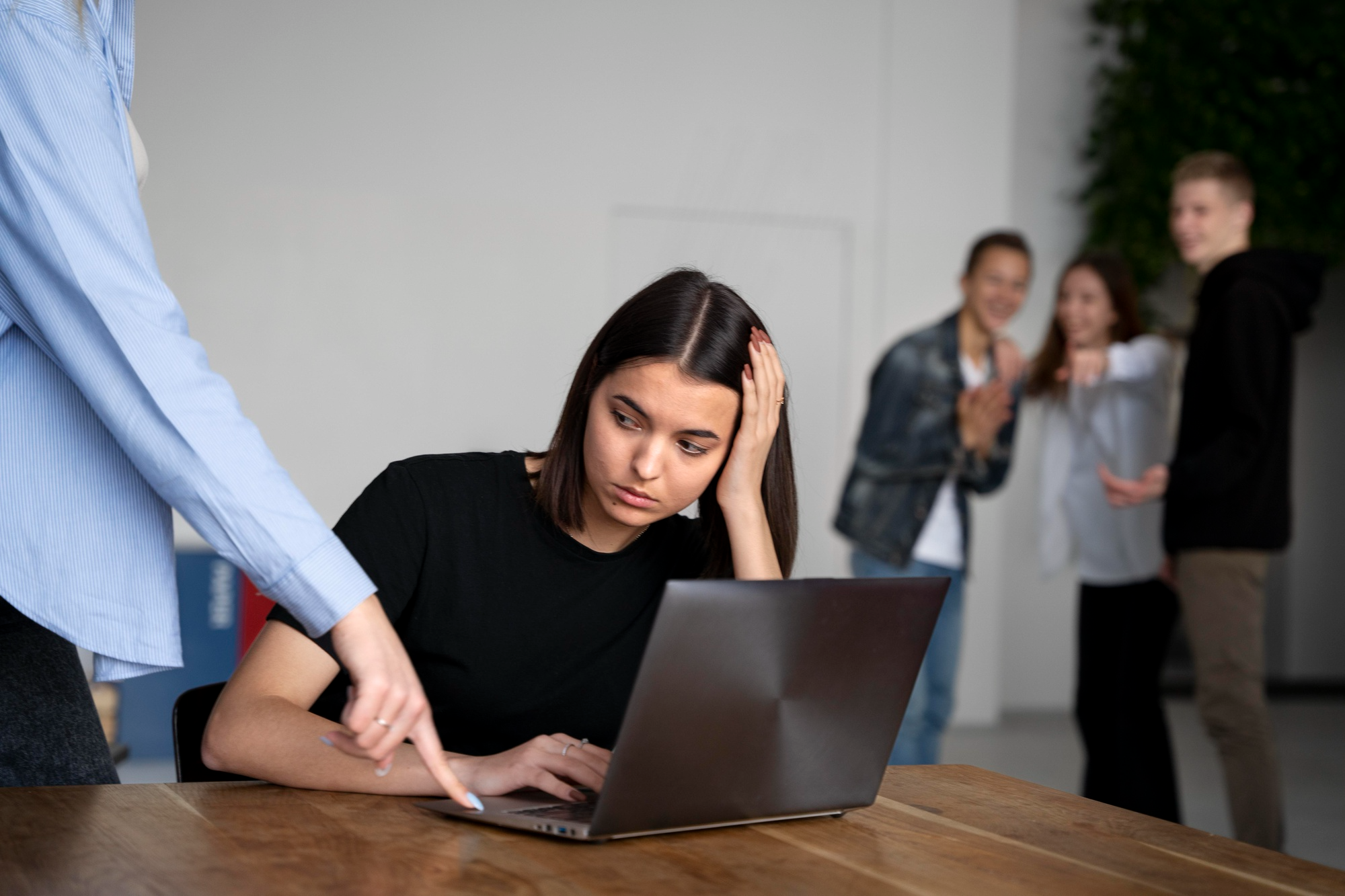 female being bullied at computer by male colleague