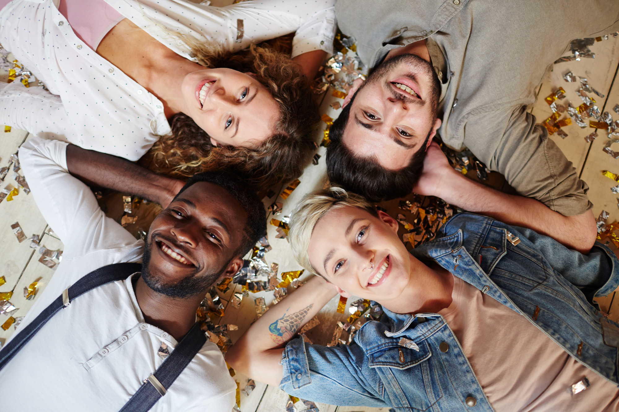 four friends looking up at camera