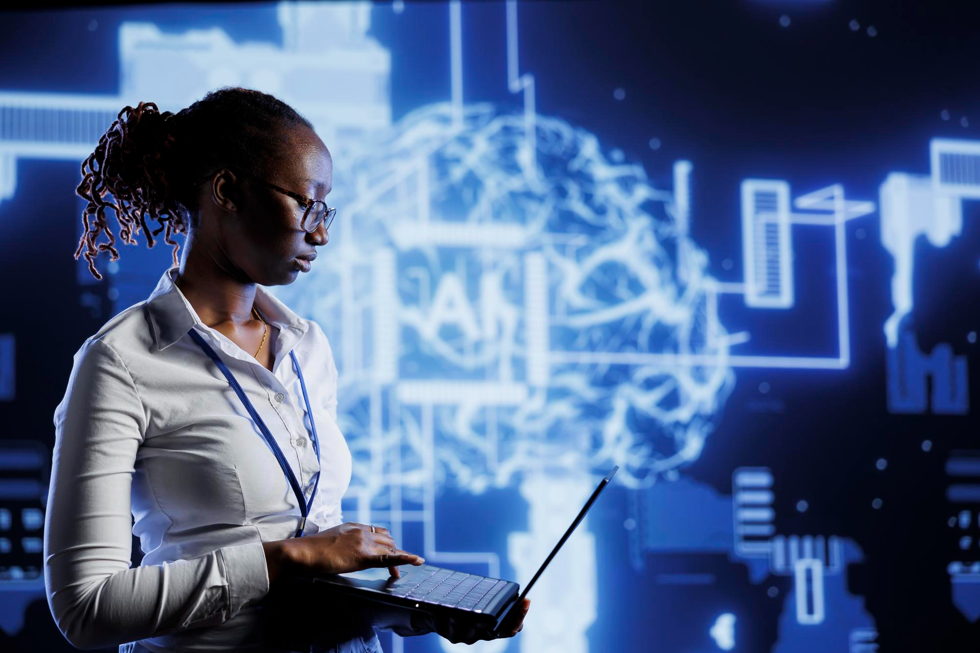 African woman looking at laptop with computer imagery