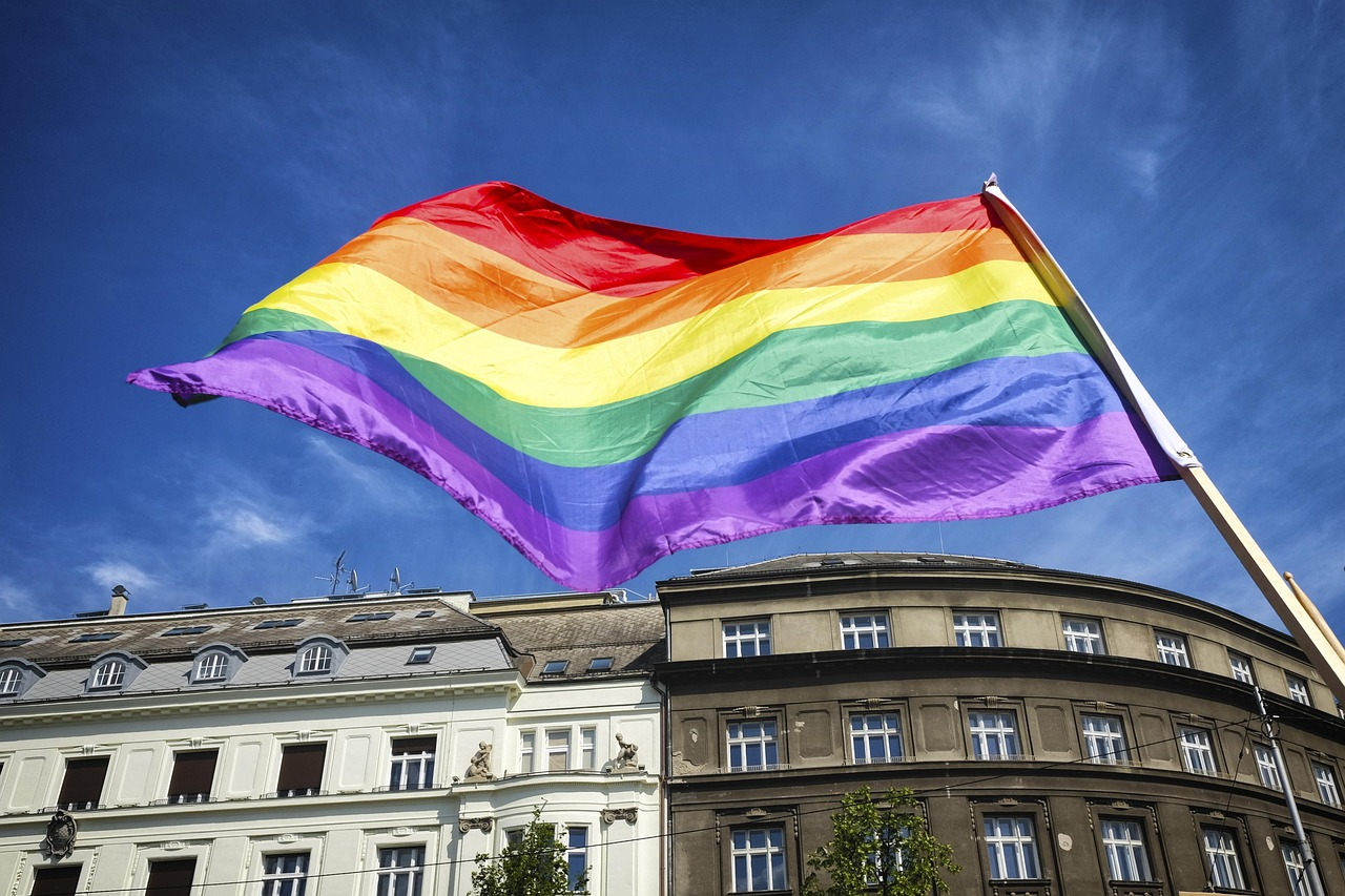 rainbow flag flies over buildings in london
