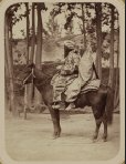 traditionally dressed S Asian man and woman on horse