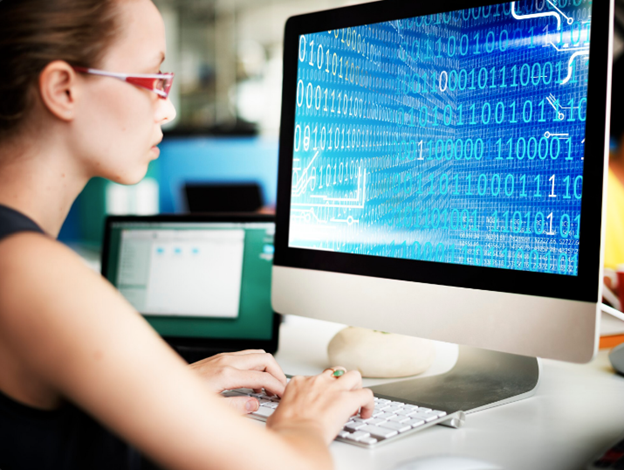 female student coding on computer