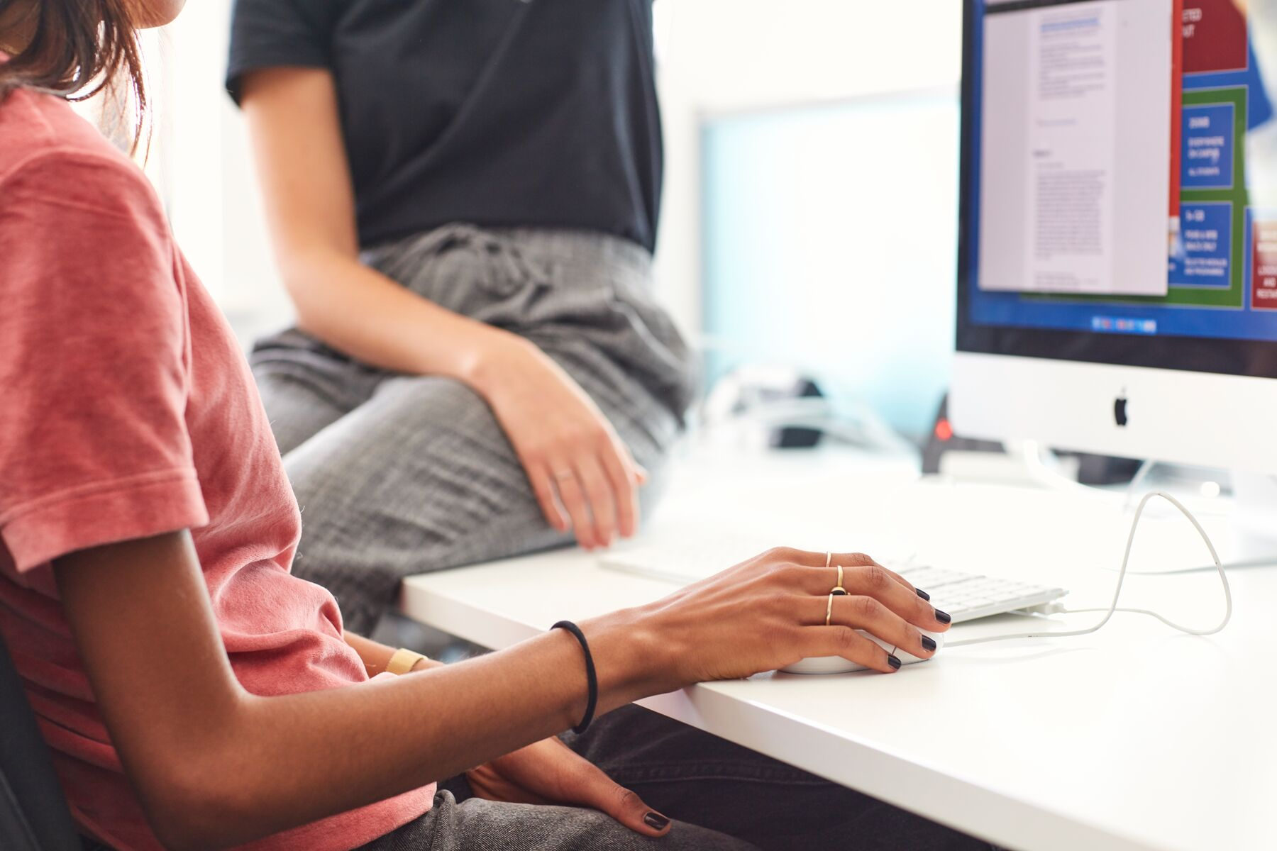 A person sitting at a desk using a computer

Description automatically generated