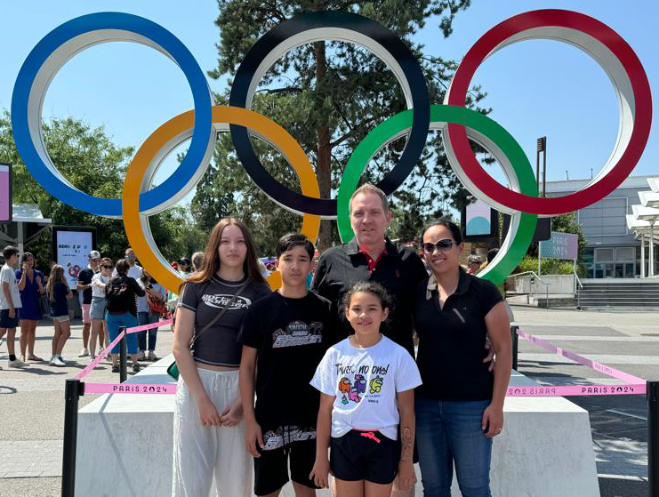 Suter Family in front of Paris Olympics sign