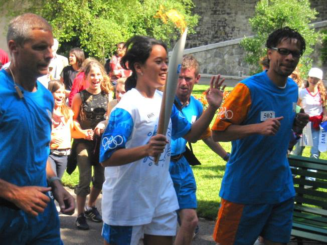 Santi running in athens carrying olympic torch